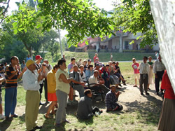a group listening to a Gospel message at a camp at Badiceni
